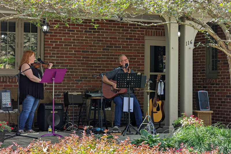 Michael Manley and Katie Harford performing on a porch in Troy Ohio